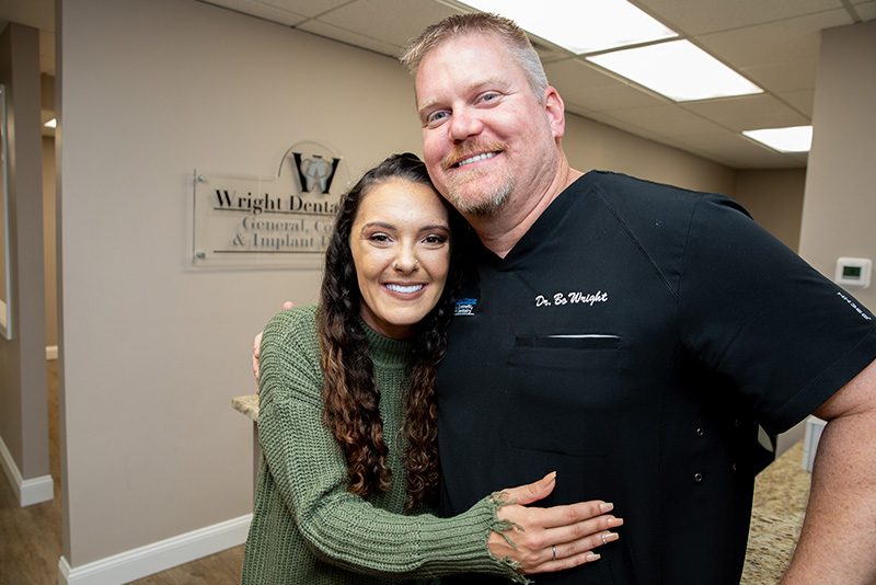 Dr. James Wright III, Posing With A Dental Patient After Receiving Full Mouth Dental Implants